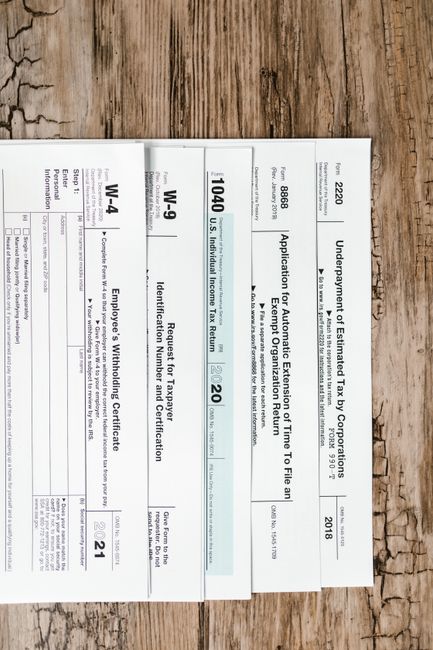 A couple reviews mortgage documents and a property tax statement at a kitchen table.